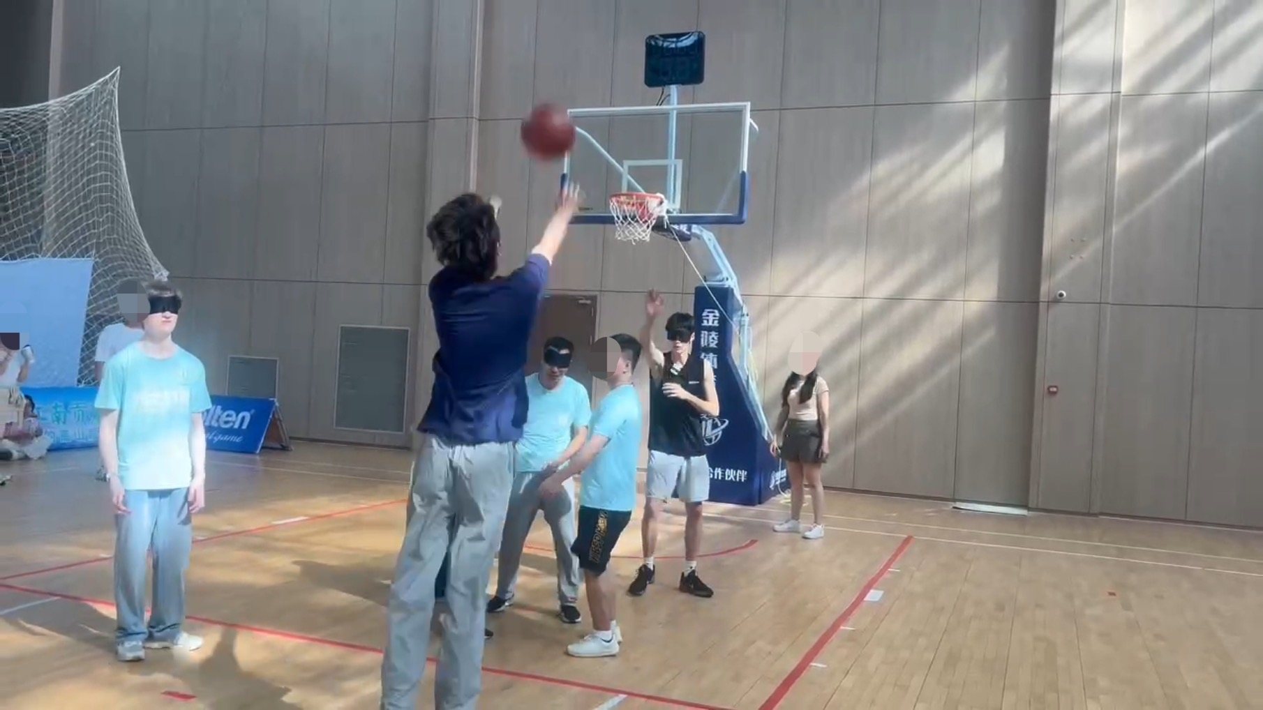 Blindfolded participants testing the audio basketball system in a gym