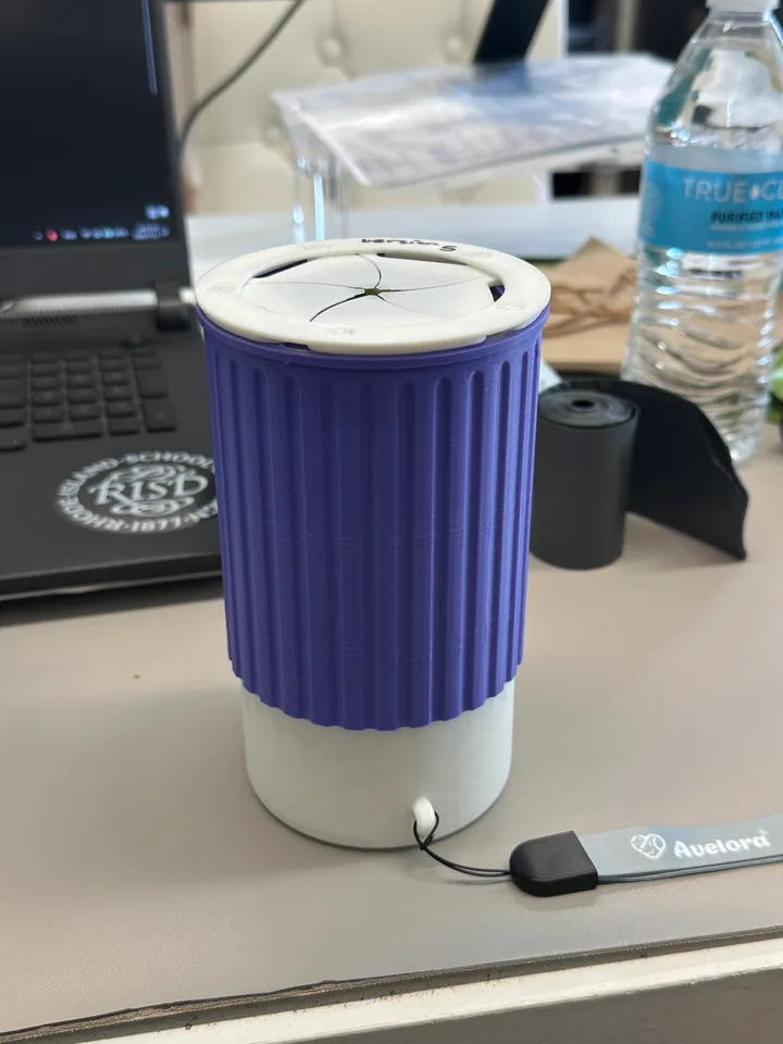 Printed pet-waste collector with five iris blades, a ribbed purple grip, and a detachable bag compartment