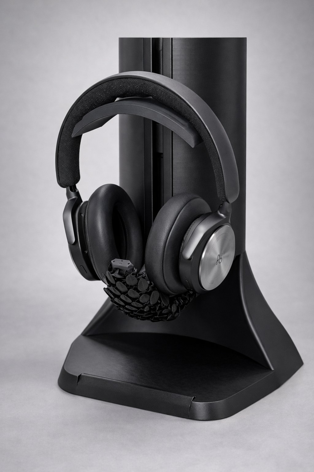 Pangolin headphone stand with its articulated protective tail deployed