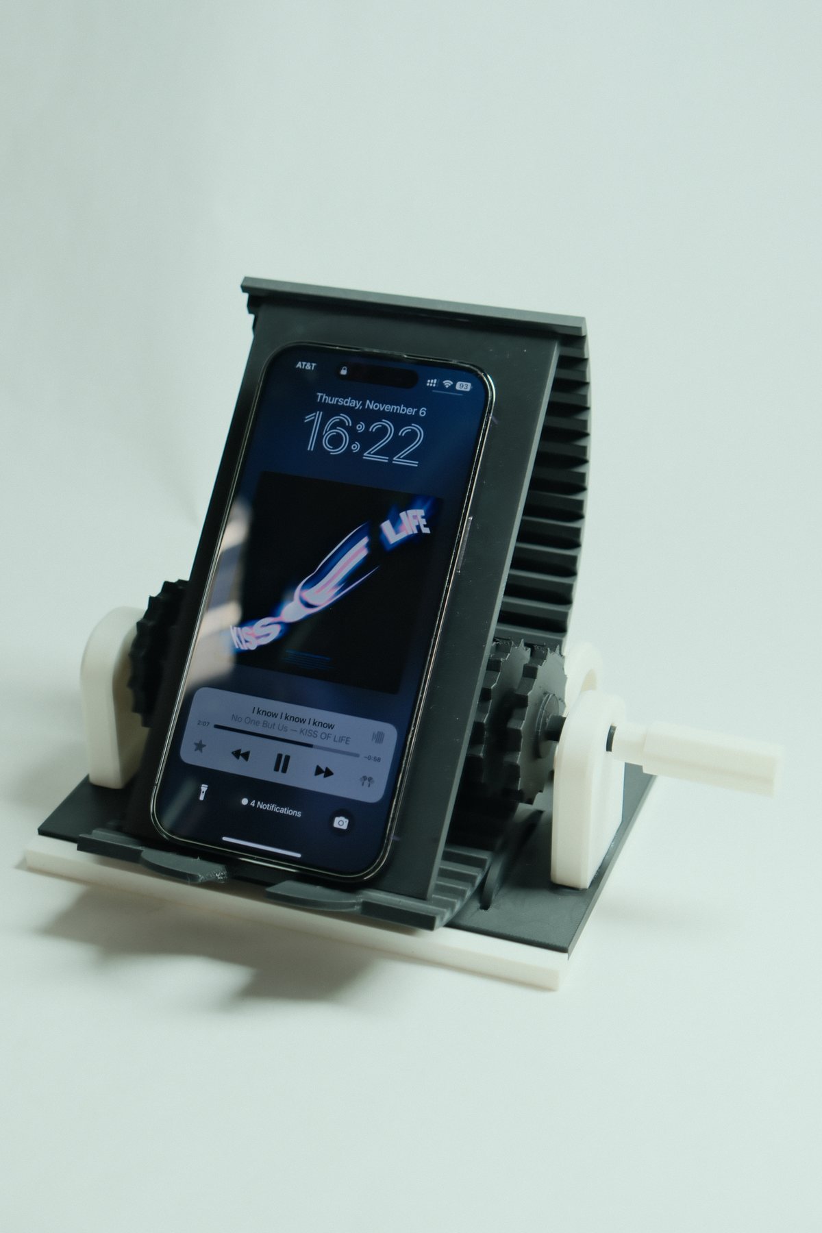Rotational phone stand with visible rack-and-gear mechanism